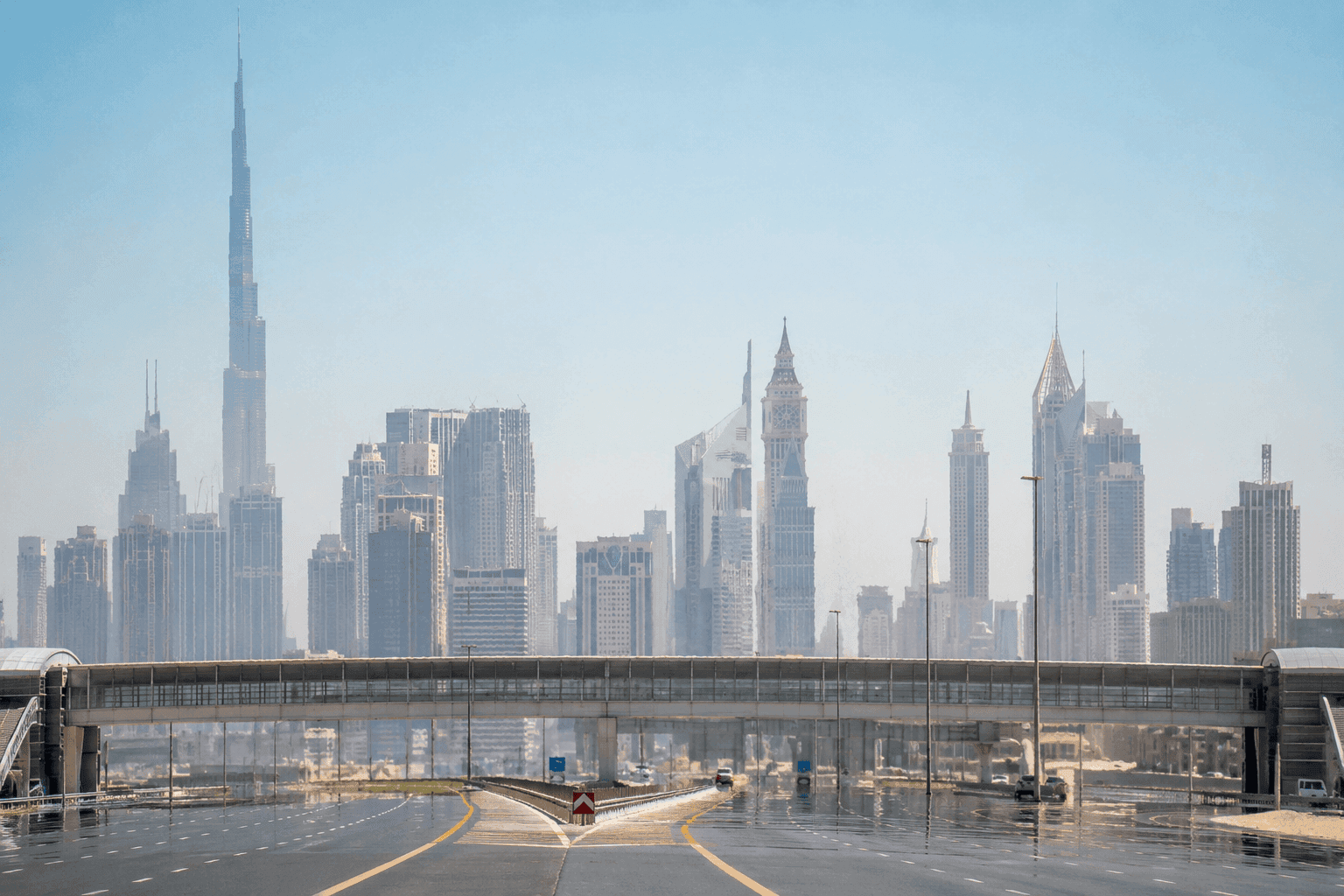 Heat haze rising over the Dubai skyline at midday with the Burj Khalifa visible through shimmering air